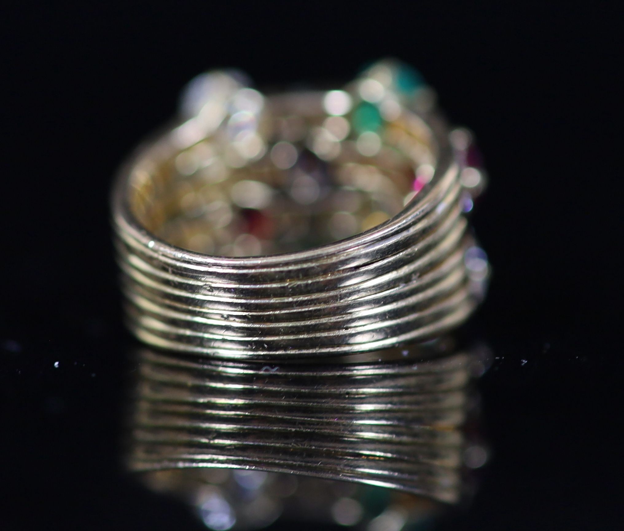 A gold, emerald, ruby, sapphire and diamond set quadruple shank dress ring